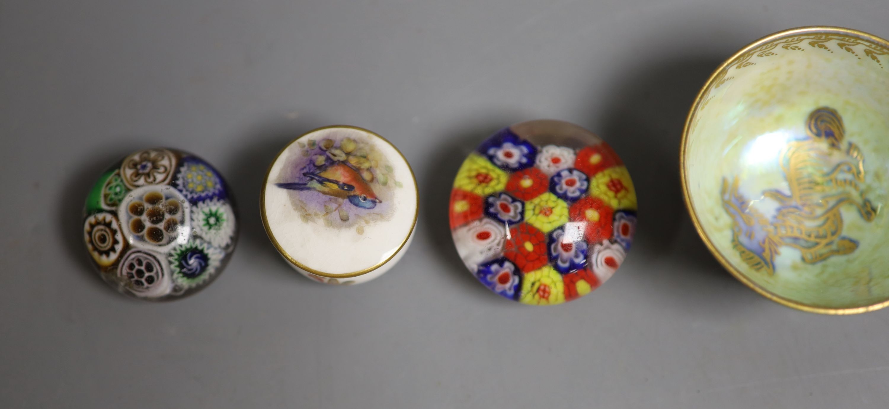 A Wedgwood lustre small cup, 4cm high, two Royal Worcester 'bird' pots & covers and three glass millefiori paperweights.